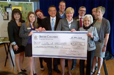 Politicians, seniors advocate Lorna Gibbs (front right) and community centre association members celebrate an additional $1.2 million from the province on April 23, 2014. photo: Twitter